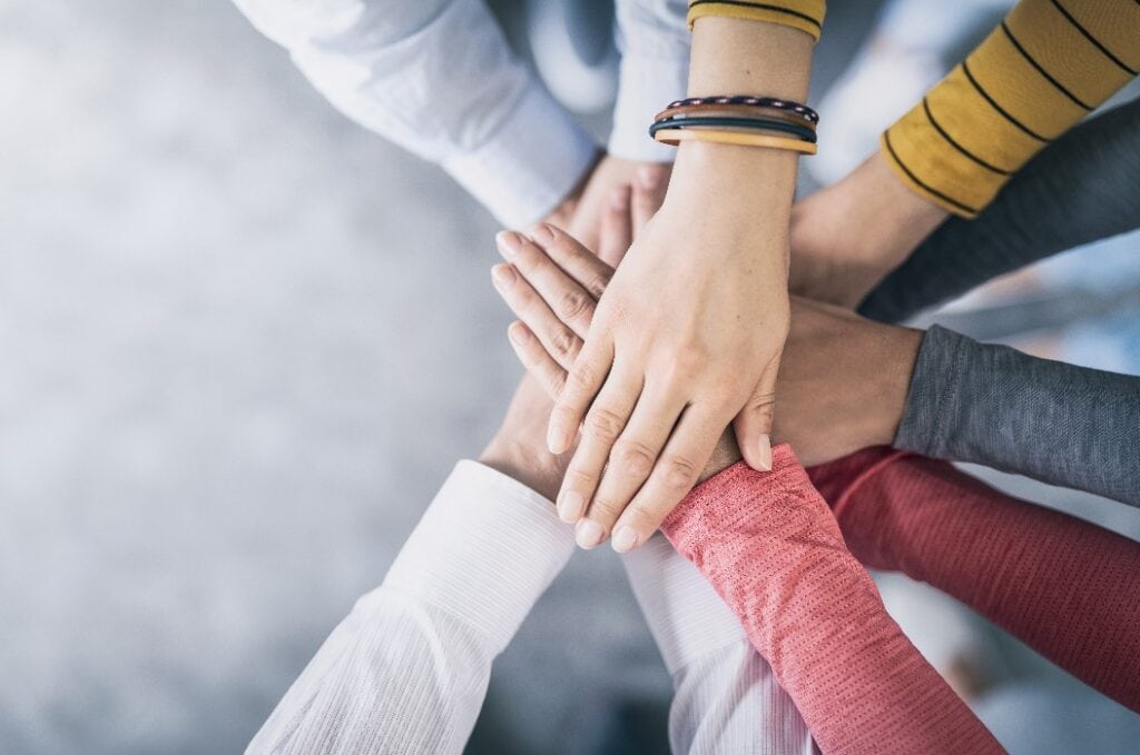 Stack of hands. Unity and teamwork concept.